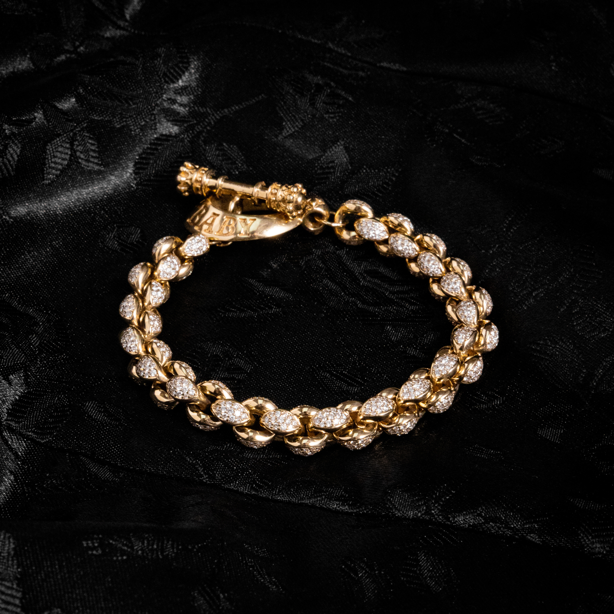 Alt Closed shot of 10k Gold Large Infinity Link Bracelet w/ Pave Diamonds on black background