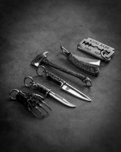 Style shot of five tools of horror pendants without chains
