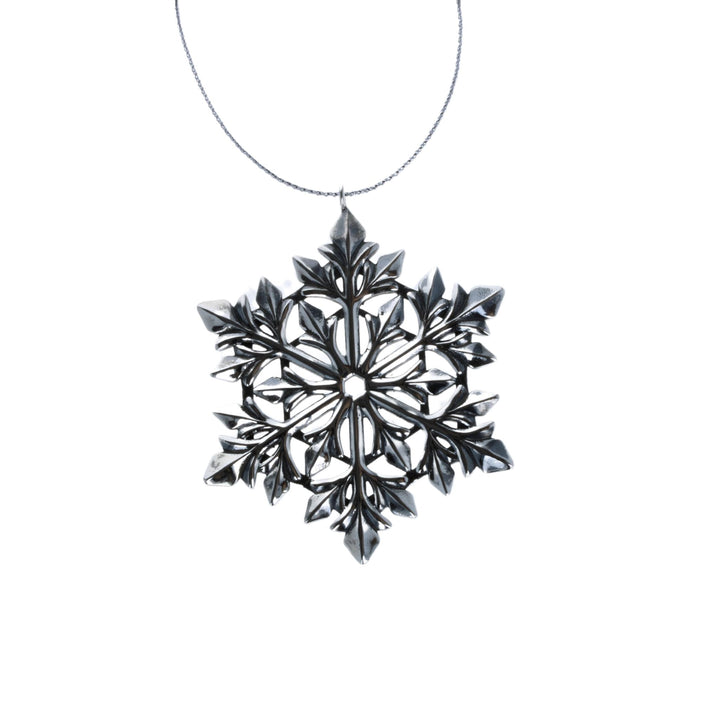 Snowflake Ornament on white background with silver cord