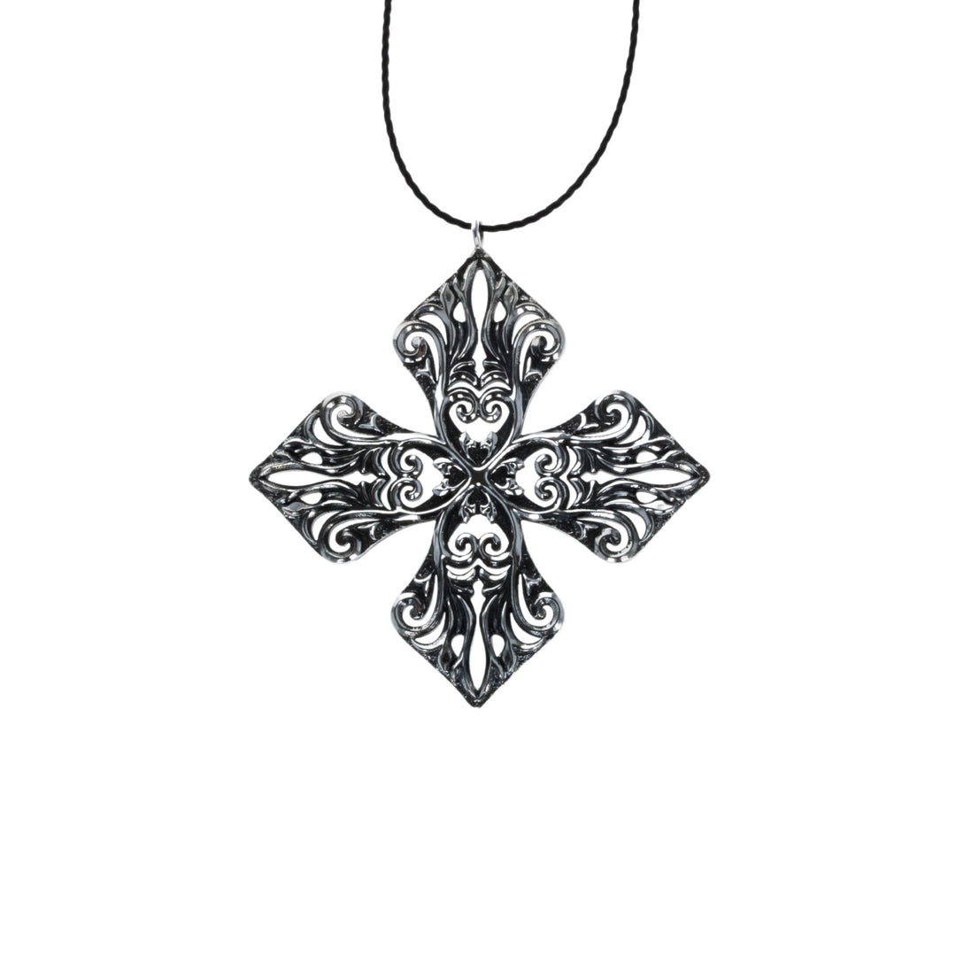 MB Cross Ornament on white background with black cord