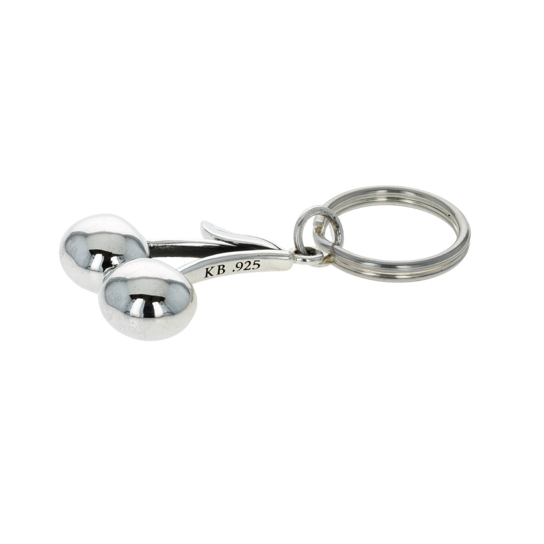 Silver keychain cherries on a white background