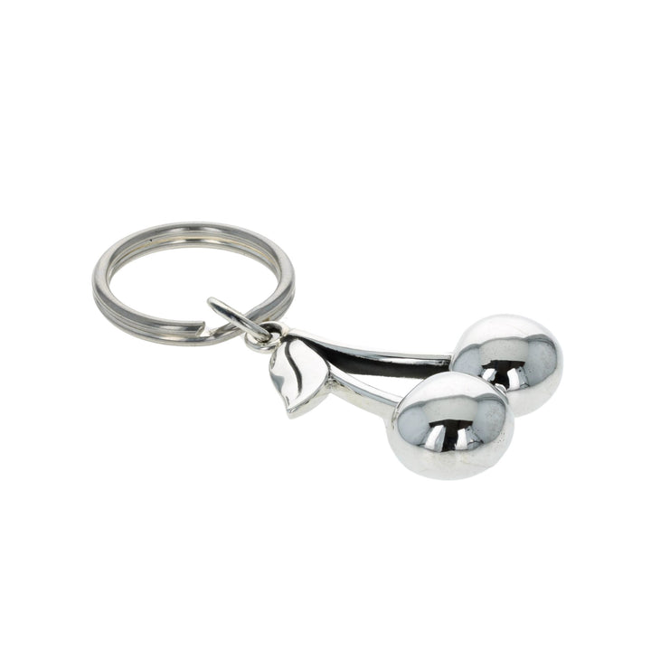 Silver keychain shaped like a cherries on a white background
