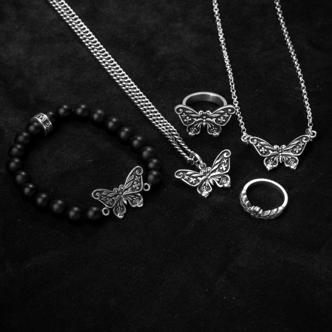 Butterfly Pendant, Necklace, Bracelet Ring and Flower Ring on black background