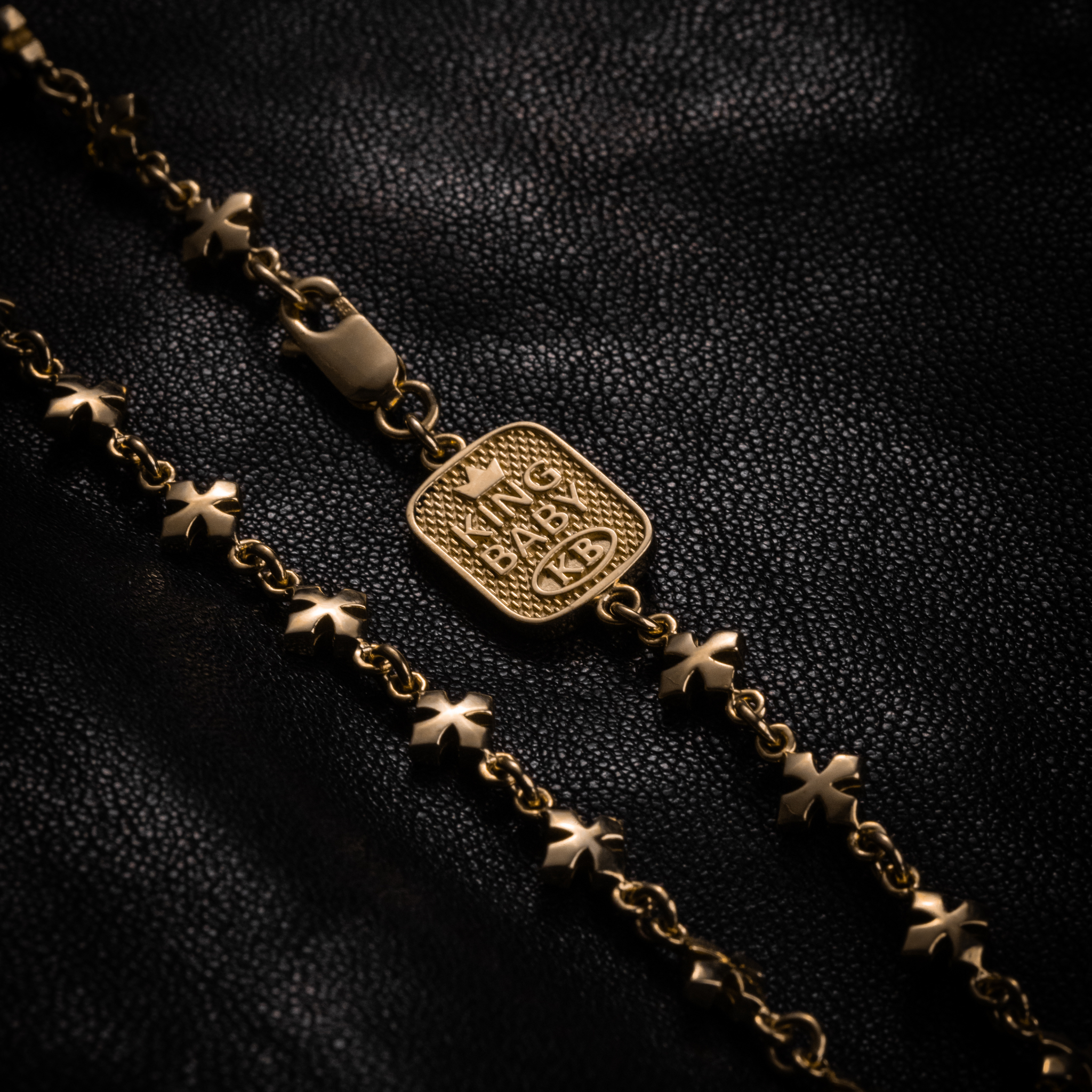 Close up of 10K YELLOW GOLD Small MB Cross Chain Necklace