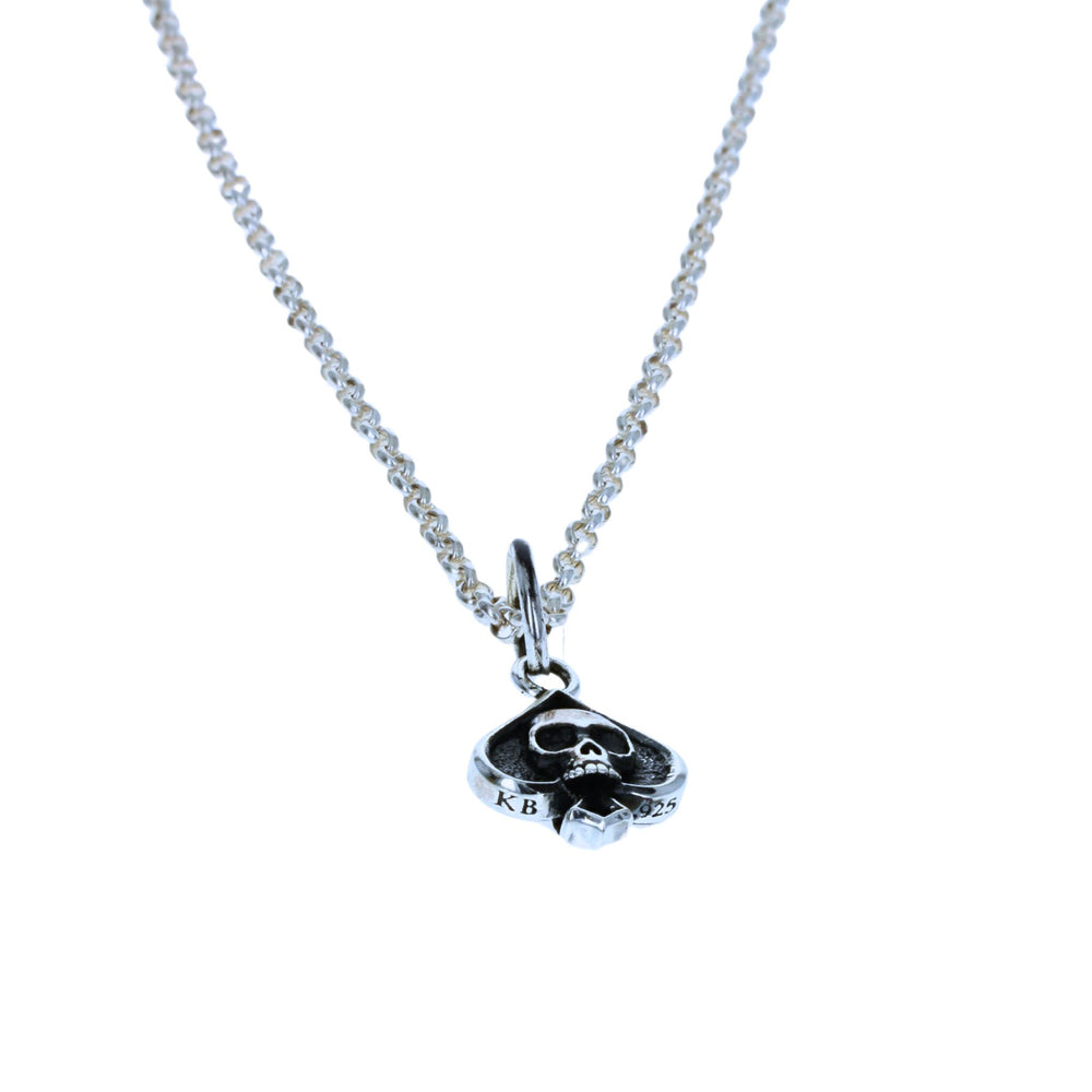 Spade Skull-shaped pendant on a chain against a white background