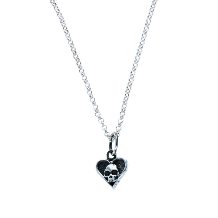 Heart with skull pendant on white background