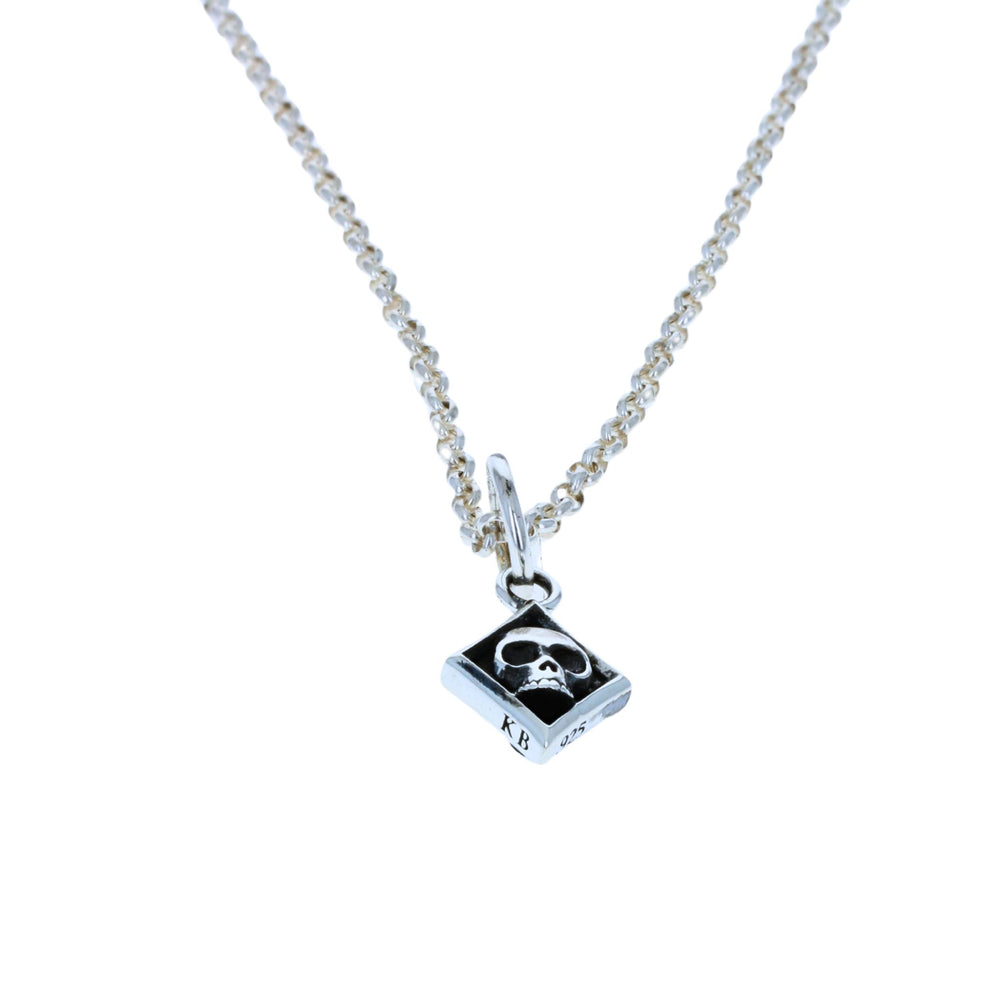 Diamond skull card suit pendant on white background