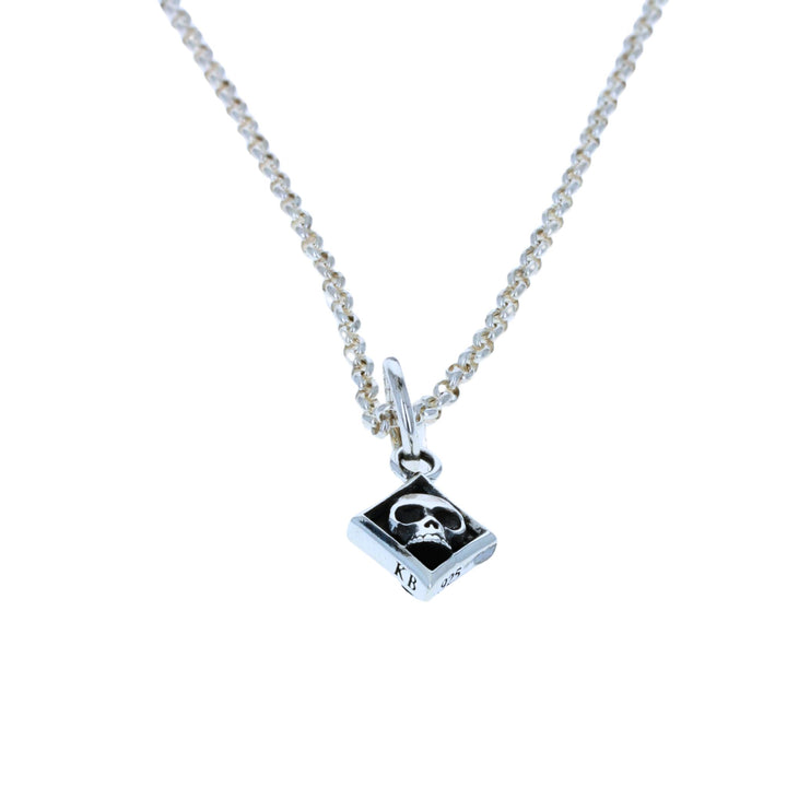 Diamond skull card suit pendant on white background