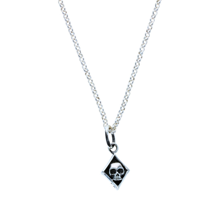 Diamond skull card suit pendant on white background