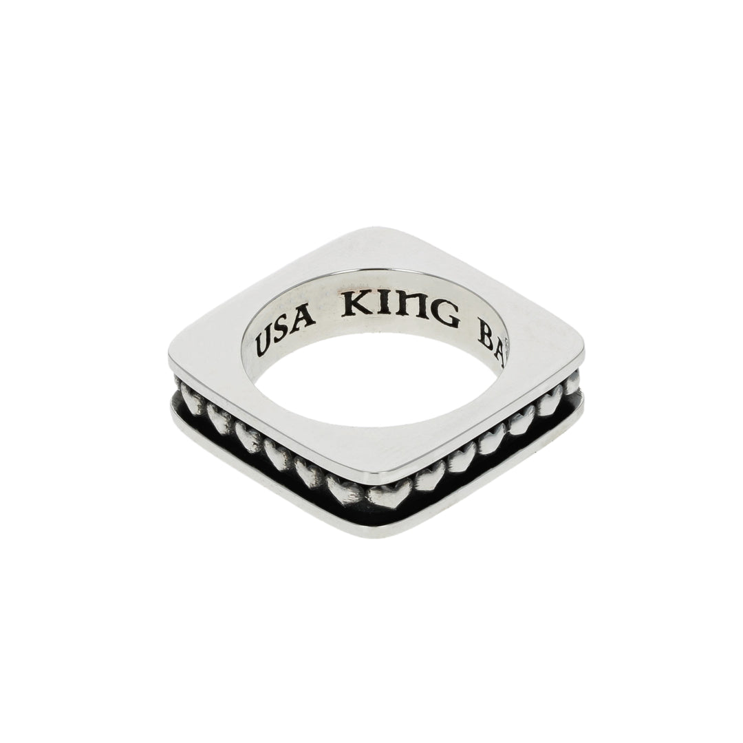 Silver heart ring with 'USA KING' engraving on a white background