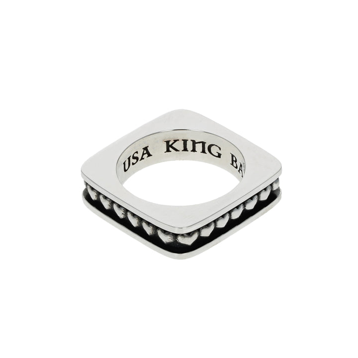 Silver heart ring with 'USA KING' engraving on a white background