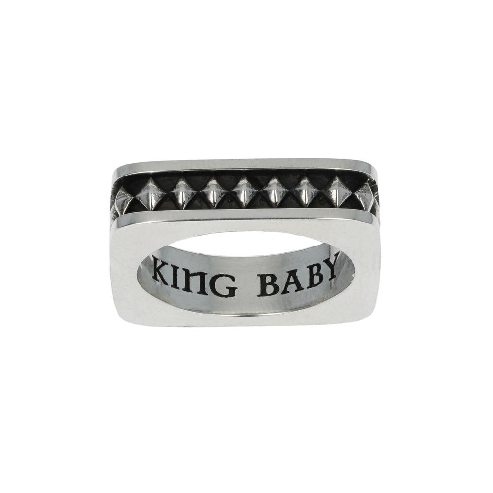 Silver diamond ring with 'KING BABY' engraving on a white background motif