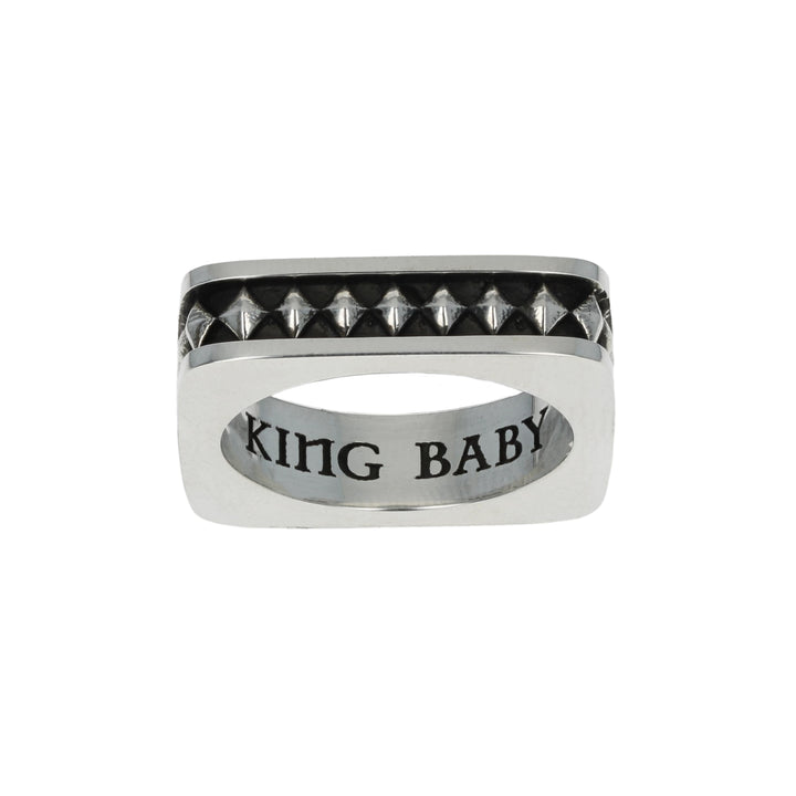 Silver diamond ring with 'KING BABY' engraving on a white background motif