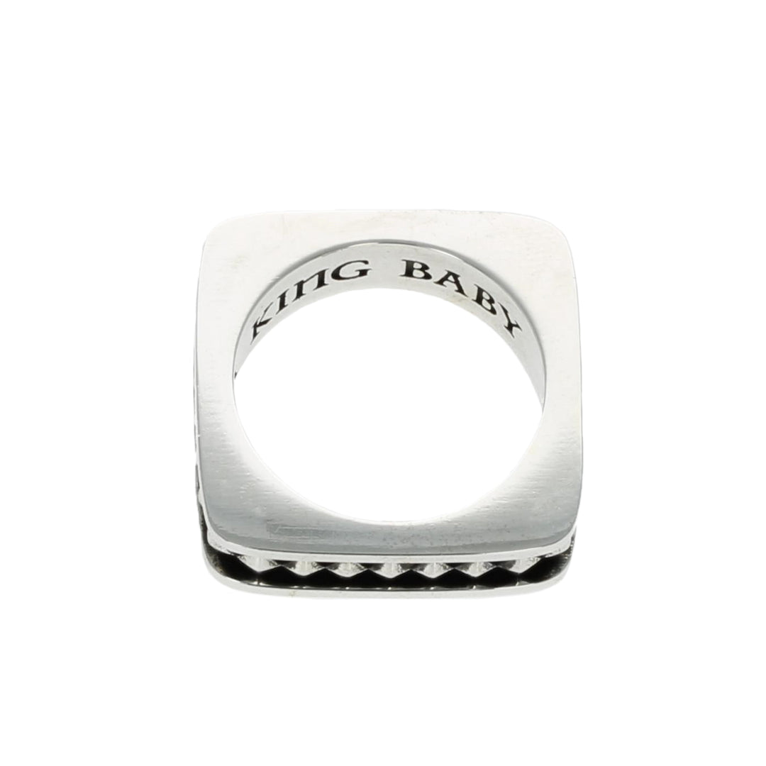 Silver ring with 'KING BABY' engraving on a white background top view