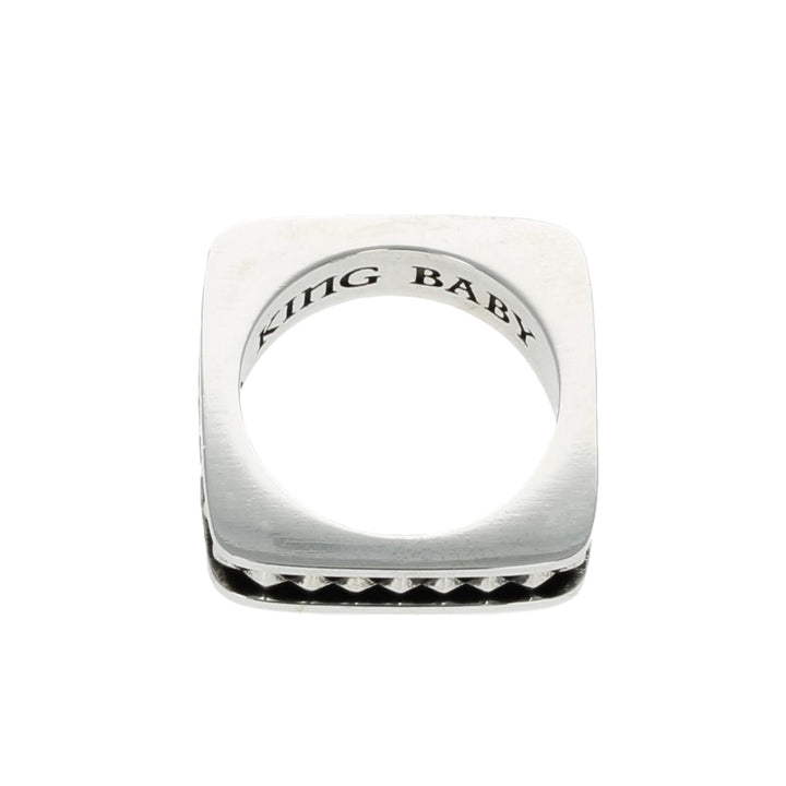 Silver ring with 'KING BABY' engraving on a white background top view