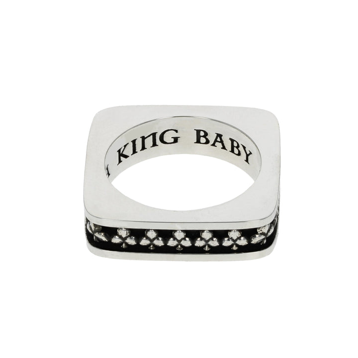 Silver club suit ring with black gemstones and 'USA KING B' engraving on a white background
