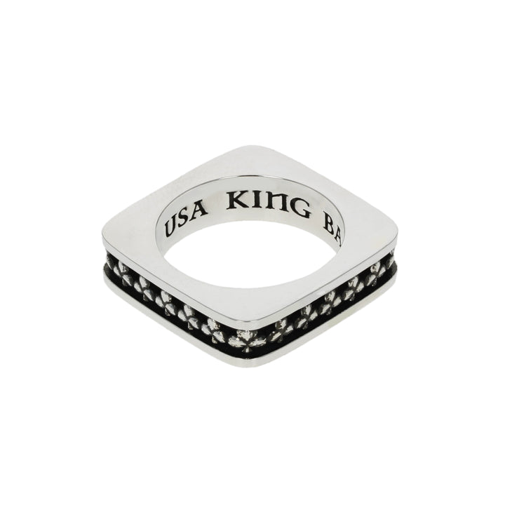 Silver club suit ring with black gemstones and 'USA KING B' engraving on a white background