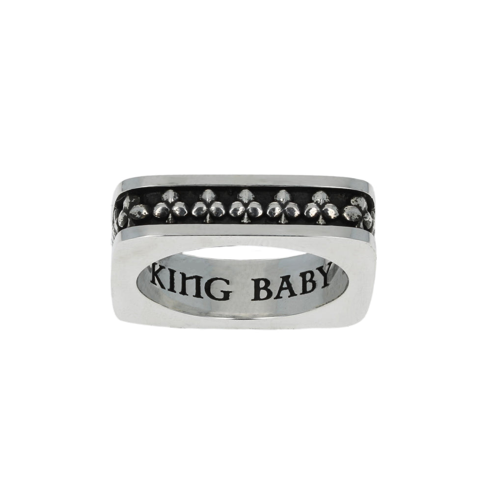 Silver club suit ring with black gemstones and 'USA KING B' engraving on a white background motif close up