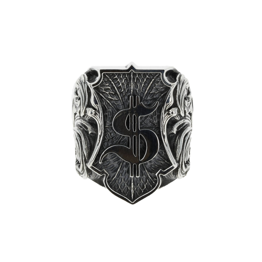 Silver ring with intricate dollar symbol design on a white background front view