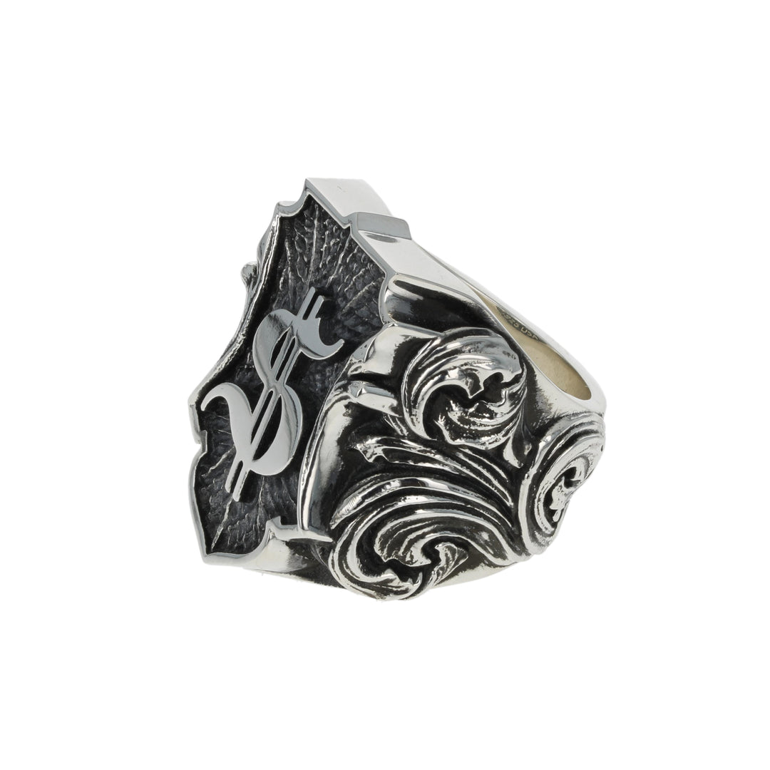 Silver ring with intricate dollar symbol design on a white background