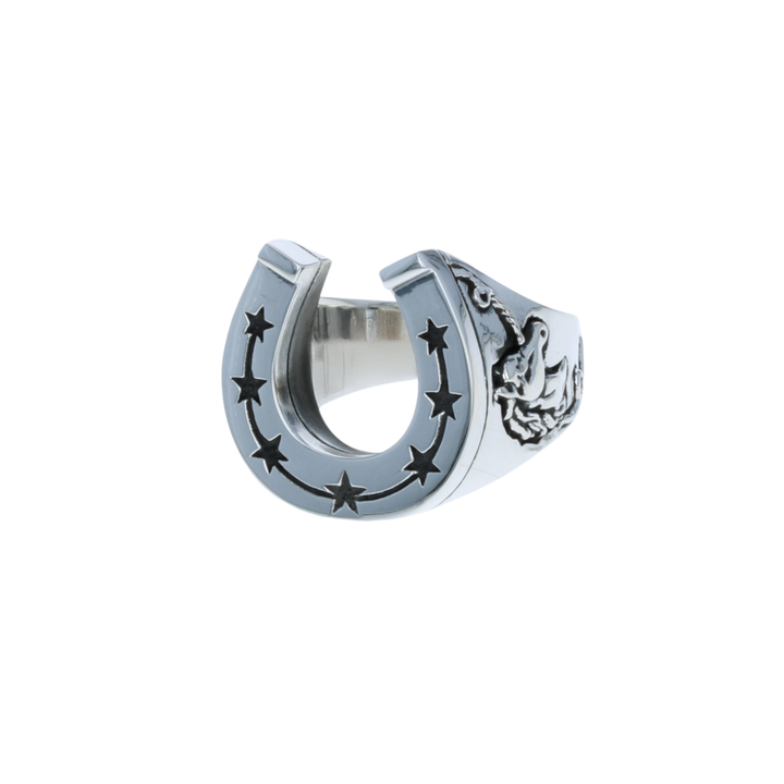 Silver horseshoe-shaped ring with star designs on a white background