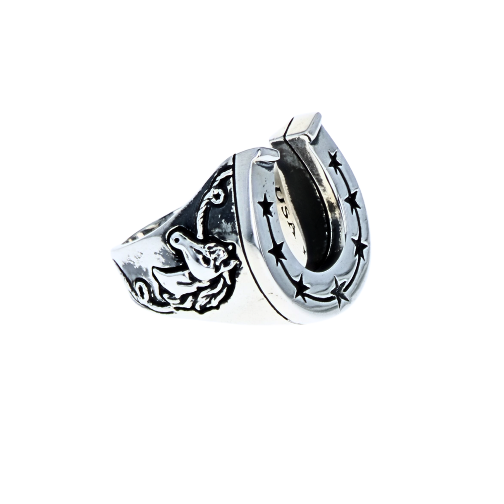 Silver horseshoe shaped ring with star design and horses on a white background