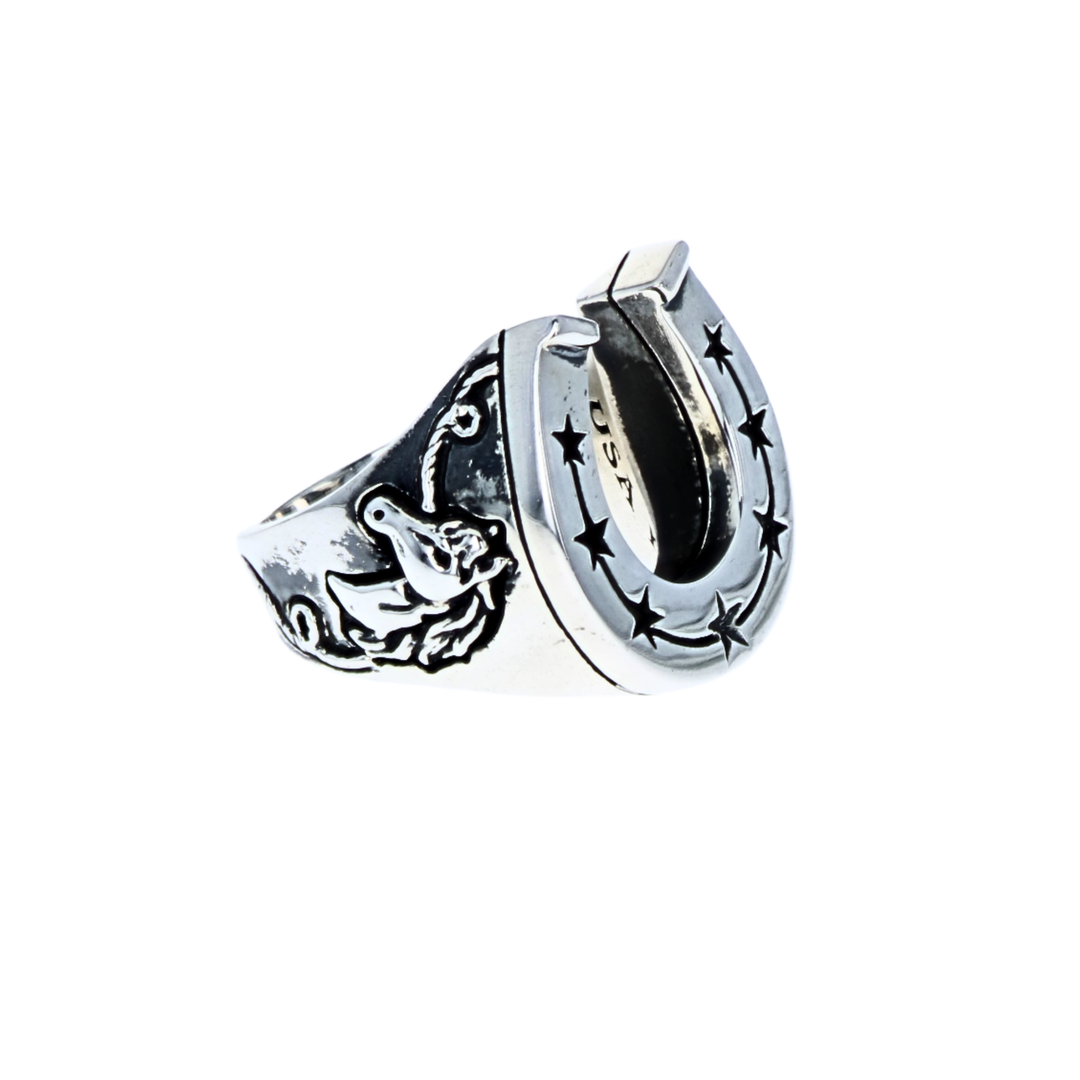 Silver horseshoe shaped ring with star design and horses on a white background