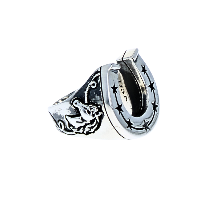 Silver horseshoe shaped ring with star design and horses on a white background