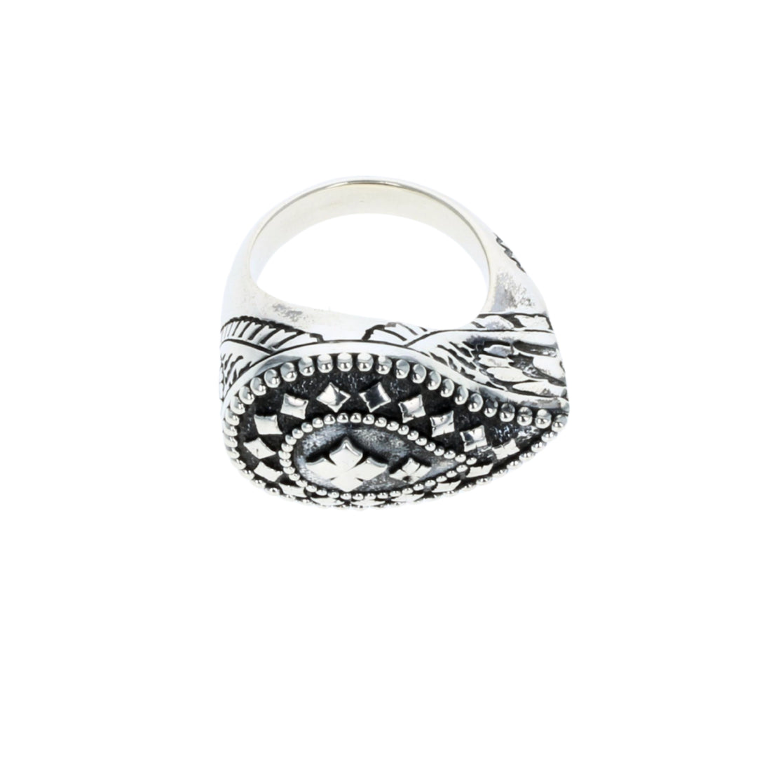 Silver ring with intricate design on a white background