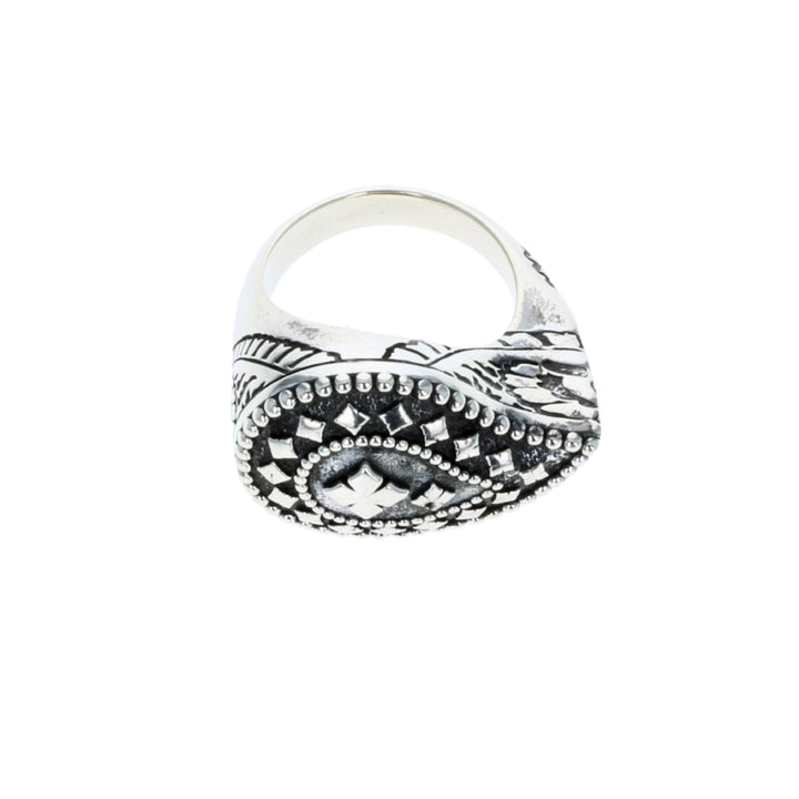 Silver ring with intricate design on a white background