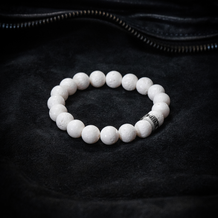 10mm White Coral Beaded Bracelet w/ Logo Ring on black cloth background