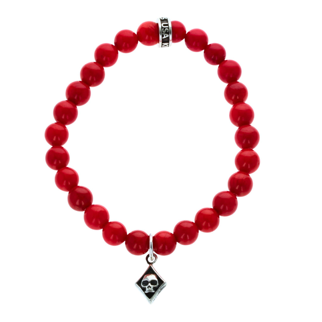 Red beaded bracelet with a diamond skull charm on a white background