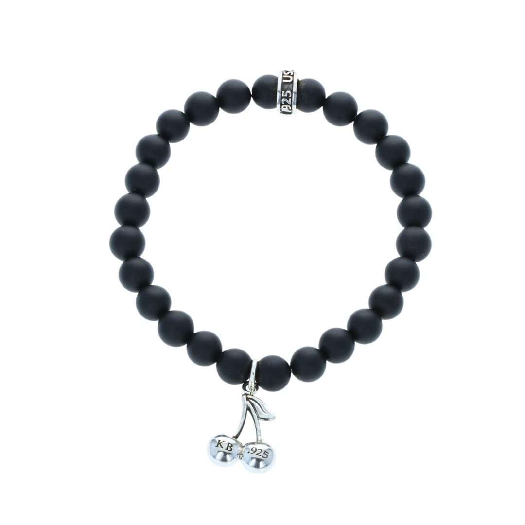 Black beaded bracelet with a silver charm on a white background back