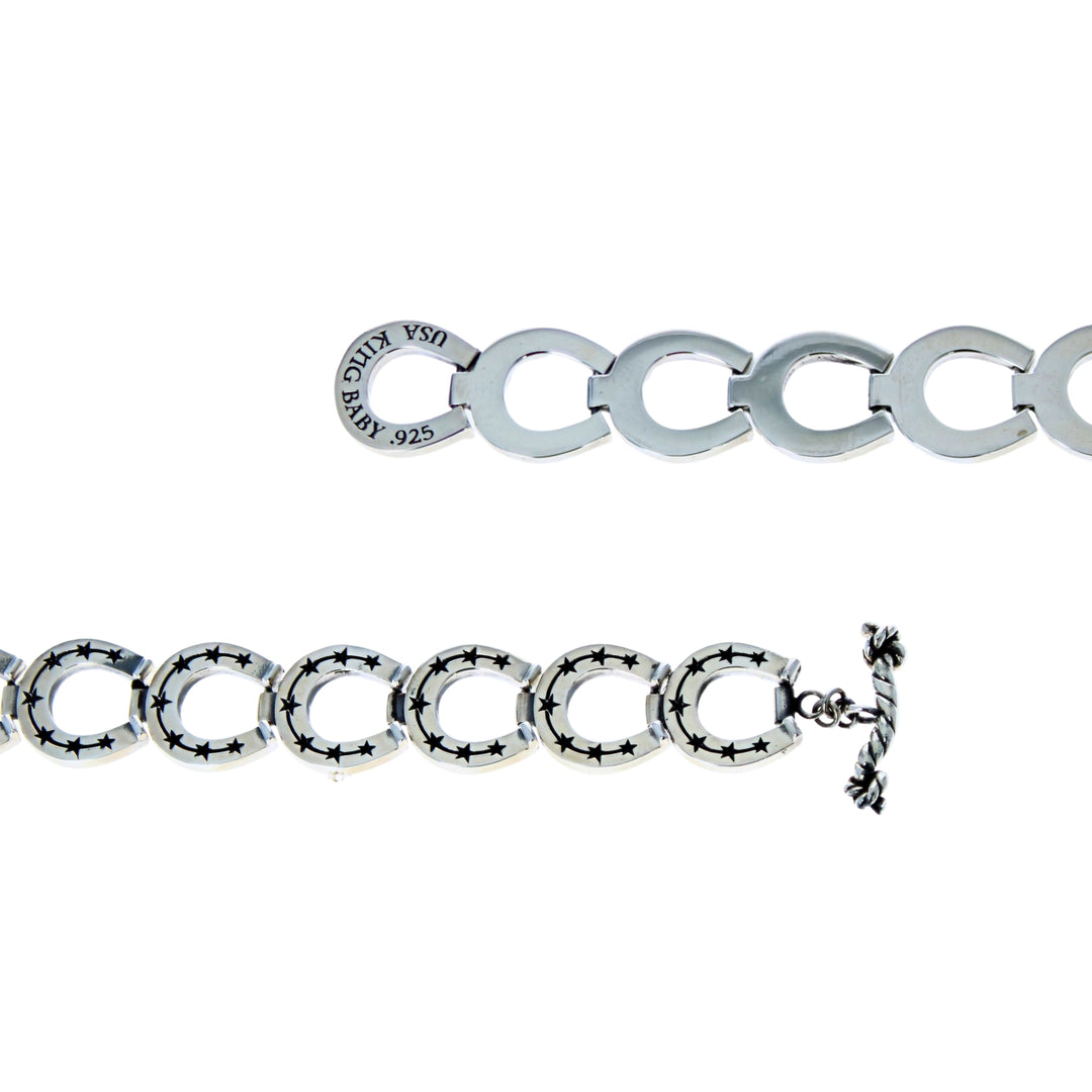 Silver bracelet with a clasp on a white background