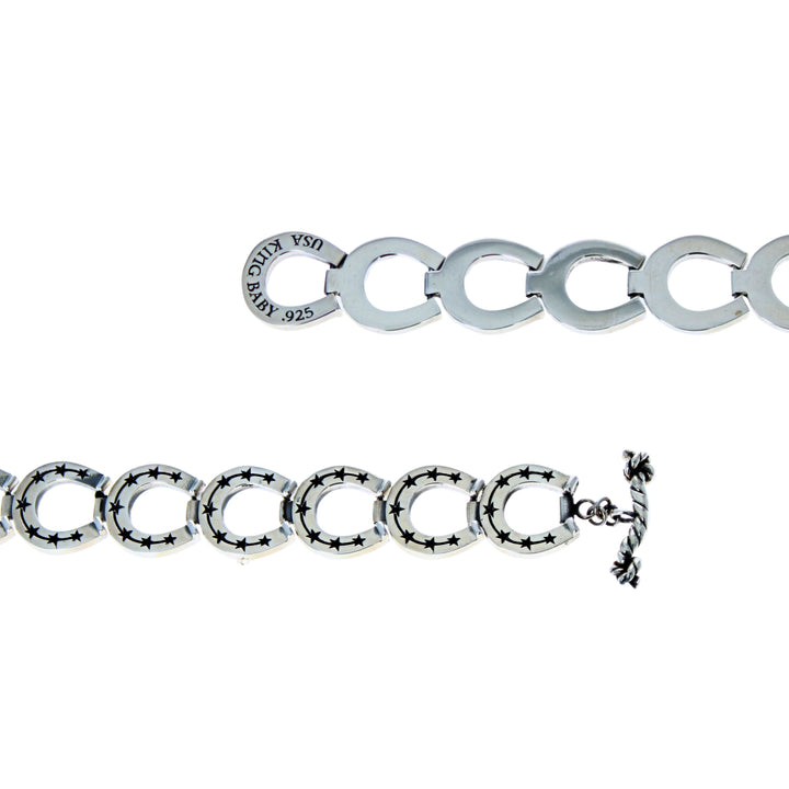 Silver bracelet with a clasp on a white background