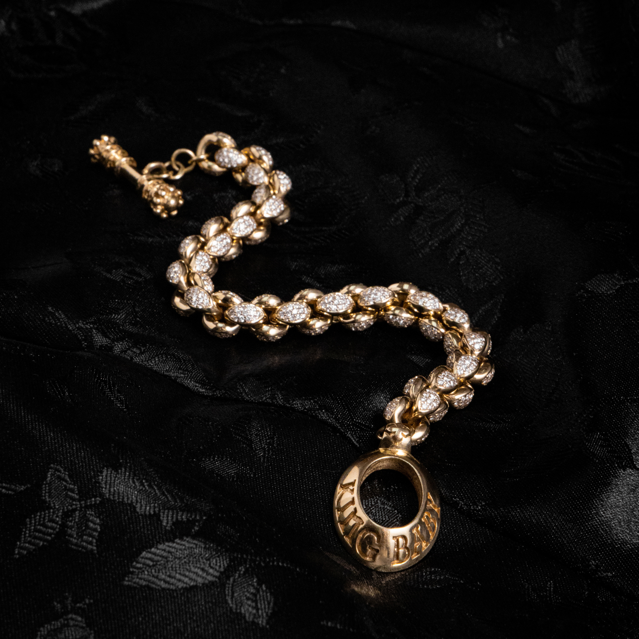 Product shot 10k Gold Large Infinity Link Bracelet w/ Pave Diamonds on black background
