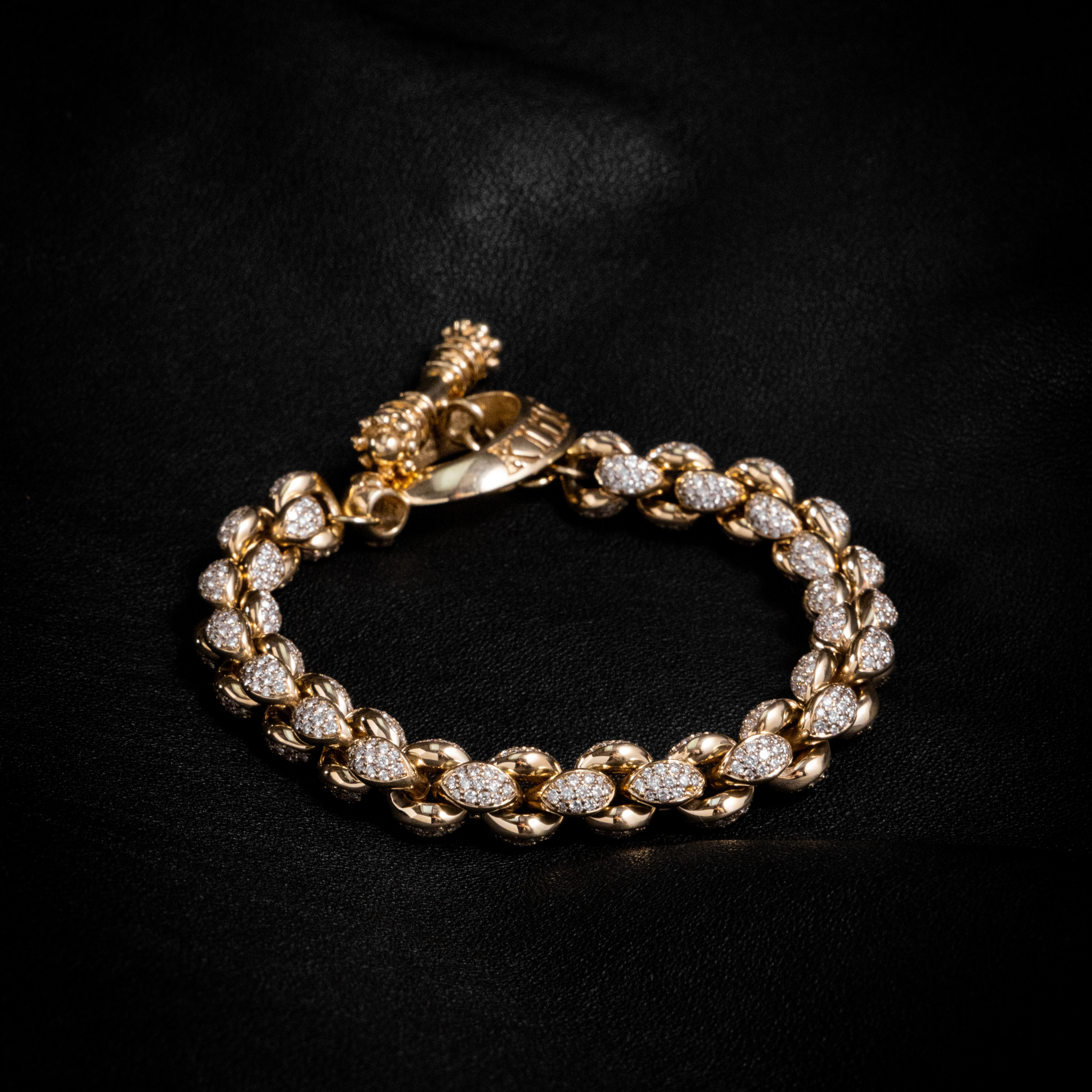Closed shot of 10k Gold Large Infinity Link Bracelet w/ Pave Diamonds on black background