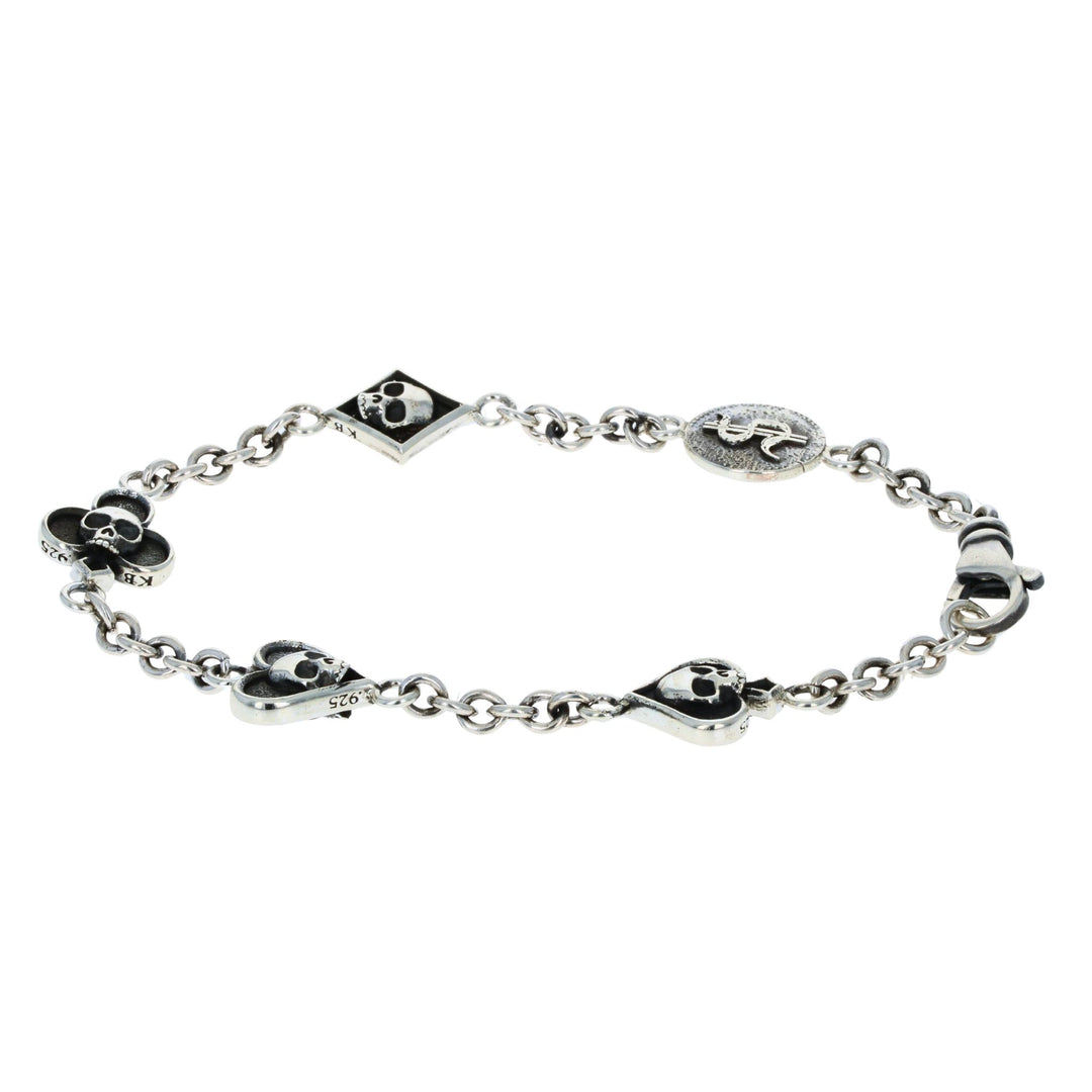 Silver bracelet with card suit skull designs on a white background