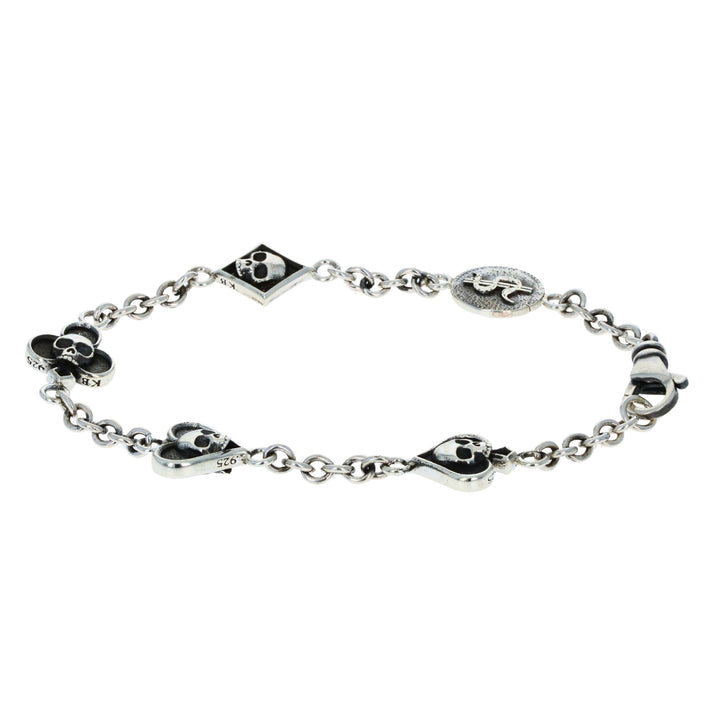 Silver bracelet with card suit skull designs on a white background