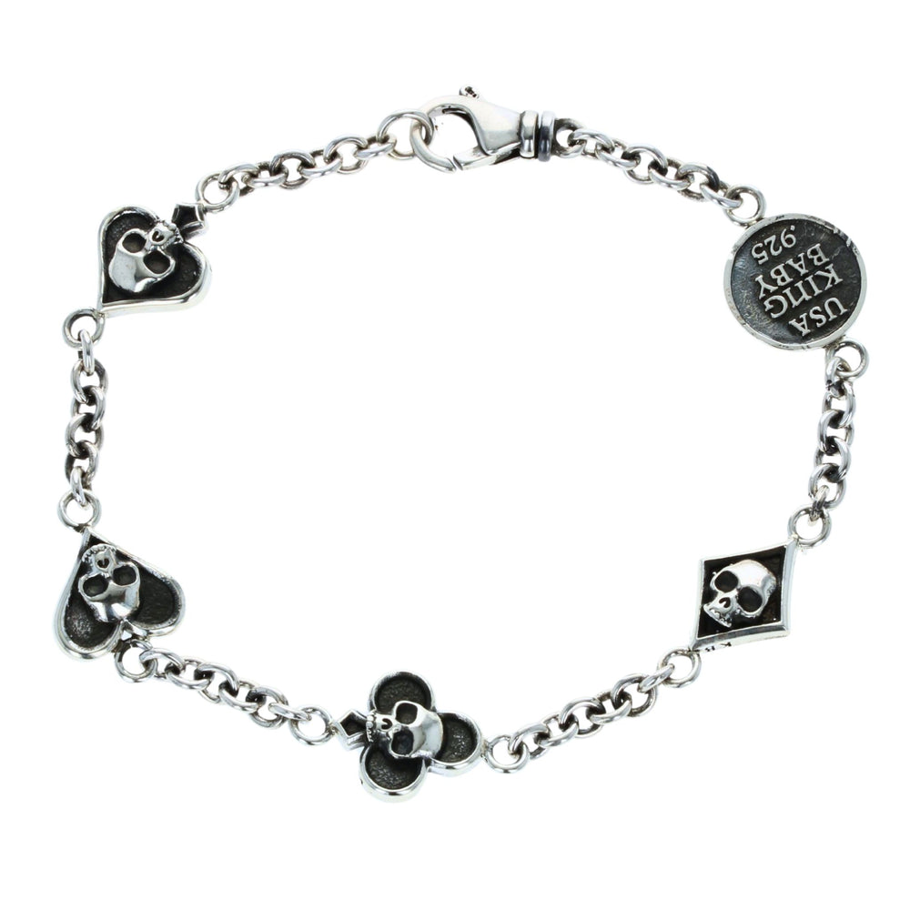 Silver bracelet with card suit skull designs on a white background