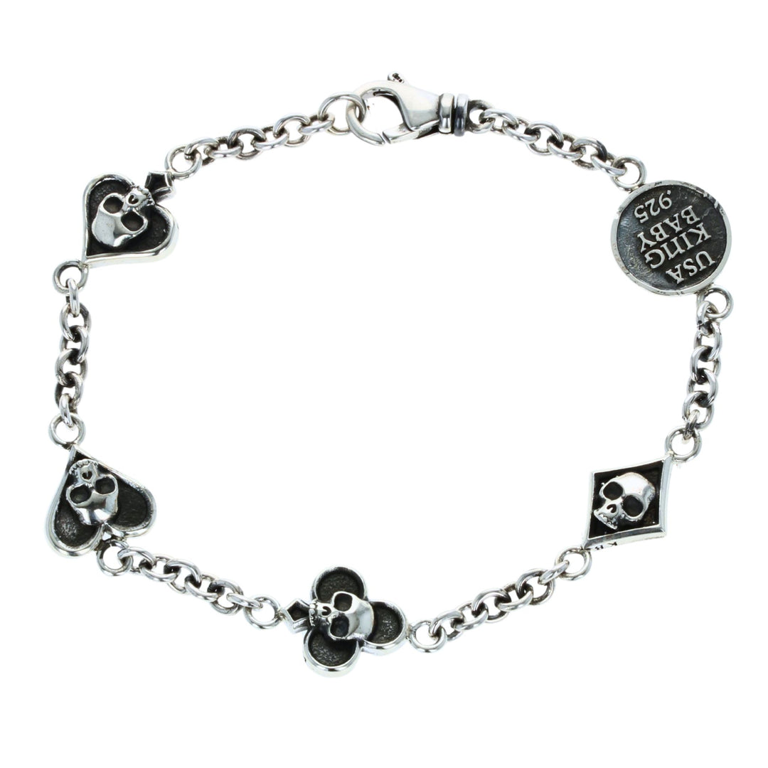 Silver bracelet with card suit skull designs on a white background