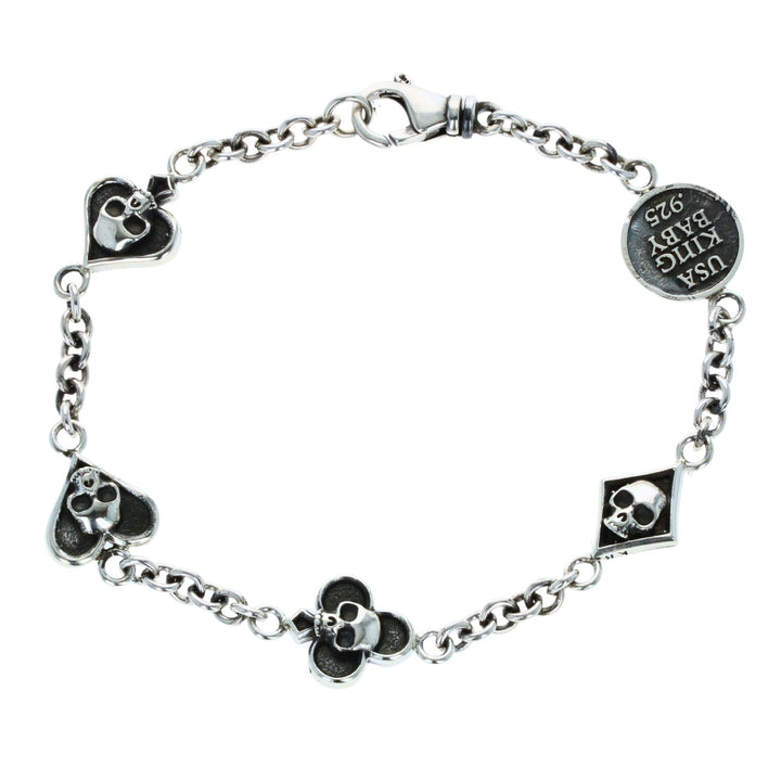 Silver bracelet with card suit skull designs on a white background