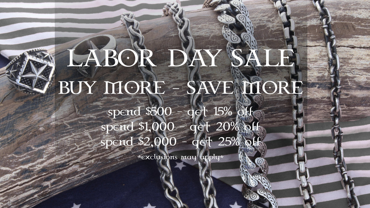 Promotional banner for a Labor Day Sale featuring multiple silver-toned chains and a silver star pendant displayed on a rustic wooden log with a striped fabric and navy flag background. Large text reads 'LABOR DAY SALE' and 'BUY MORE - SAVE MORE' with discount details below.