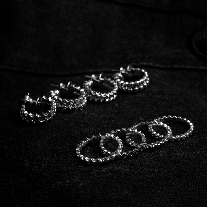 micro stackable silver rings in front of micro stackable earrings