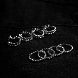micro stackable silver rings in front of micro stackable earrings