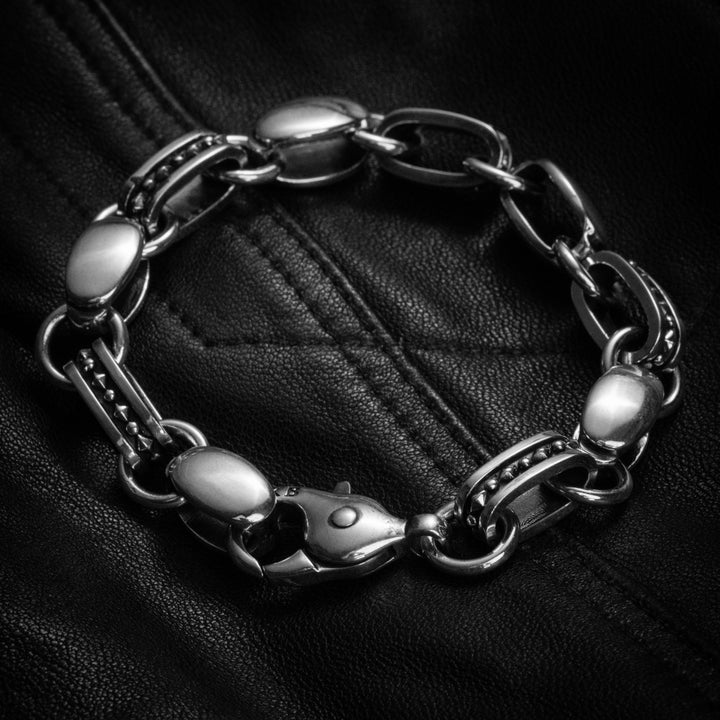 Oval link bracelet on black leather background