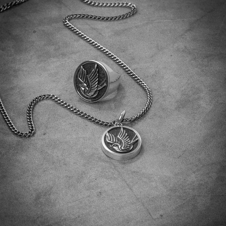 Pendant Sparrow  and ring on grey background