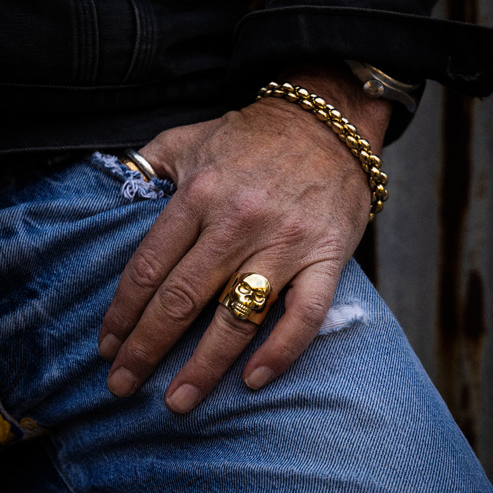 10K Gold Small Classic Skull Ring and 10k large infinity link bracelet on model