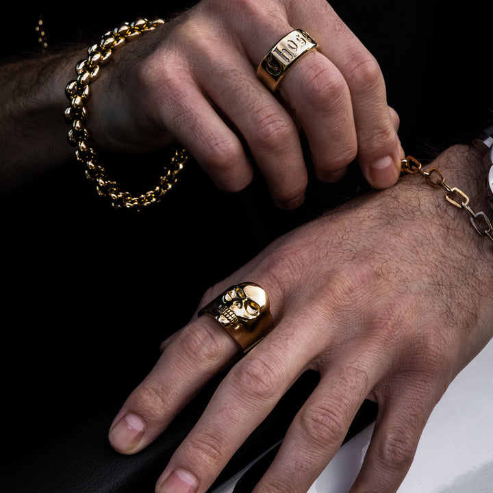 10K Gold Small Classic Skull Ring with other 10k pieces on model