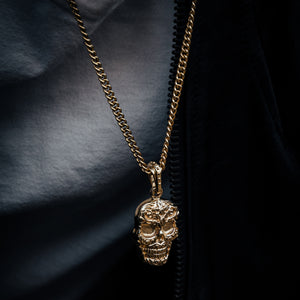 Model wearing 10K Gold Carved Baroque Skull Pendant